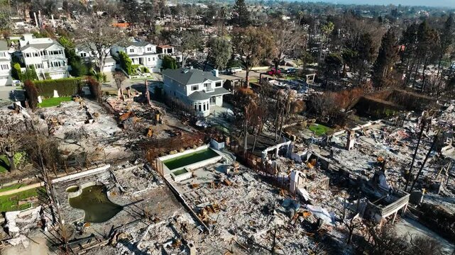 Drone flying over spared homes in middle of fire destruction in Los Angeles