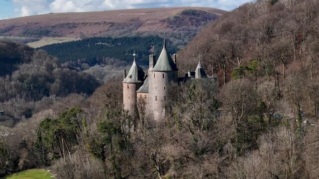Stunning drone footage of Castell Coch near Cardiff, showcasing its fairytale architecture, lush woodland setting, and historic charm through cinematic aerial and scenic shots.