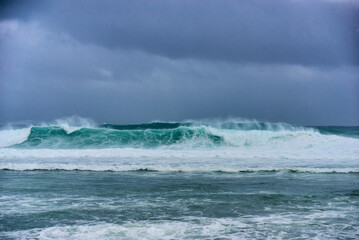 View of powerful high waves crashing in the Indian Ocean during a cyclone in Mauritius, capturing the intensity of the storm
