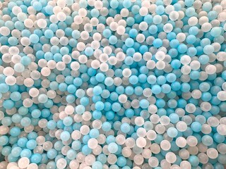 full frame collection of blue and white plastic ball toys for children's ball pools in indoor children's play areas, can be used for wallpaper or background