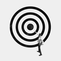 Businessman pointing at center of large target symbol. Concept of focus, goal achievement, success,...