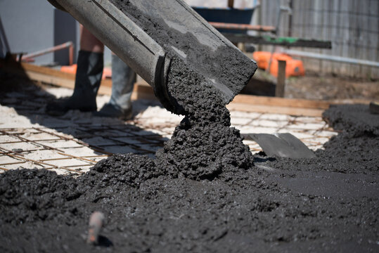 Coloured concrete pouring out of cement truck chute