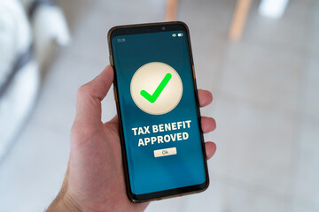 Tax benefit approved notification on smart phone.