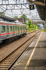 Obraz premium Display the side of the electric train car enters the train station.