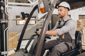 Warehouse worker driving forklift in modular building industry