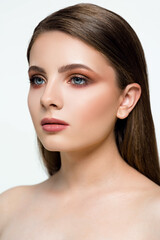 Obraz premium A young woman poses gracefully with flawless skin and expertly applied makeup, showcasing her striking features and serene expression