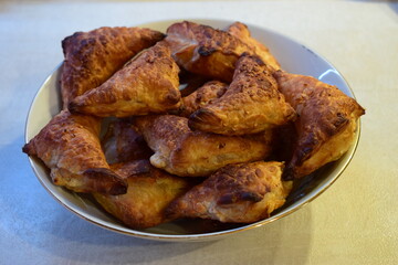 Flaky Triangular Pastries in a Bowl