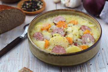A bowl with traditional German potato soup with sausages