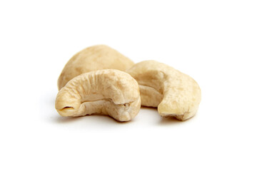 Close-up of three raw cashew nuts arranged on a white surface, showcasing their natural curves and textures. Perfect for healthy eating concepts