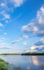 Beautiful blue sky with a few clouds and a river in the background