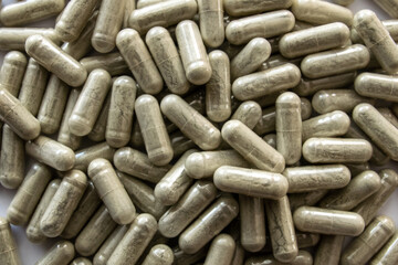 Green transparent tablets or pills on the white background.