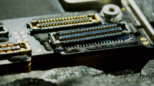 Close-up 4K video capturing the delicate process of installing a new connector onto a circuit board. The precise technique using tweezers to carefully place the component at 30fps with macro details.