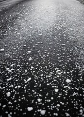 embeded stone on the asphalt road in rain, closeup of photo. Rainy Road Surface