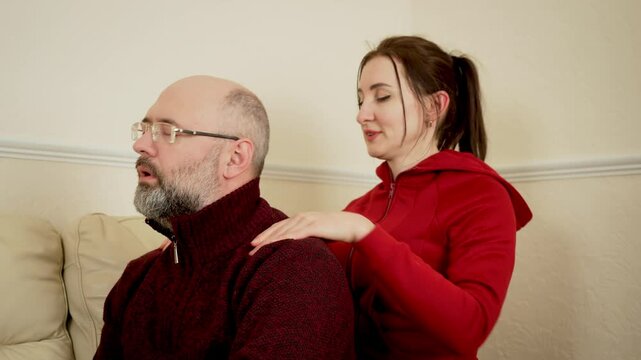 Man and woman enjoying gentle shoulder massage. Blissful family gatherings, appreciating life, couple feeling grateful. Husband and wife sharing caring touch, experiencing relaxation and warmth