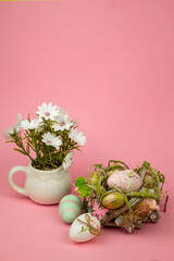 Easter colorful eggs on a pink background. Easter Composition Eggs in the Nest