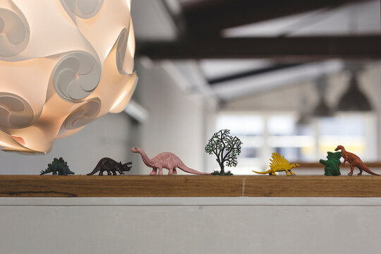 Plastic dinosaurs on ledge in cafe