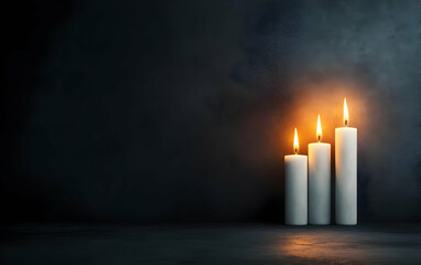 A serene setting featuring three lit candles casting a warm glow against a dark background, perfect for creating a tranquil atmosphere.