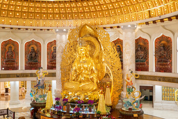 A stunning Golden Guan Yin Statue in a serene Temple, exuding tranquility and cultural depth