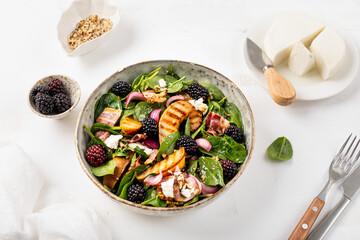 Grilled pear salad, Fresh salad with pears, spinach, cheese, walnuts, blackberries and dressing