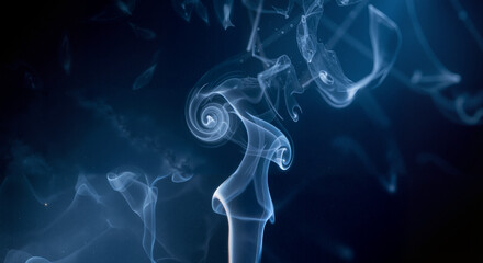 Fototapeta premium Dynamic Blue Smoke Swirls Against Black Backdrop