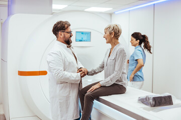 Fototapeta premium Doctor Consulting Elderly Patient During MRI Scan in a Medical Facility
