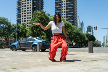 Latin dancer performing modern urban dance in city street