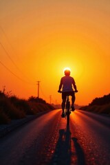 Silhouette of cyclist riding bicycle on asphalt road during sunset, sun shining brightly behind the person.