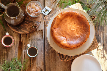 basque cake with coffee. Wooden background. San Sebastian	
