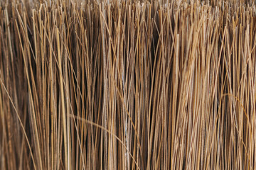 Macro shot of Indonesian lidi broom, crafted from dried palm leaf ribs. Popular cleaning tool in...