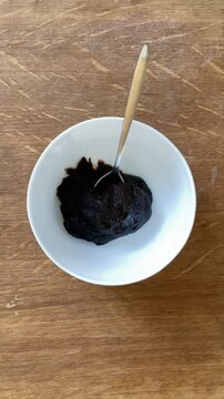 Pouring cream on top of the traditional Finnish M&auml;mmi Dessert&ndash; Easter Rye Pudding 