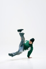 Urban dancer, dressed vintage, executing acrobatic spin, defying gravity with precision against...