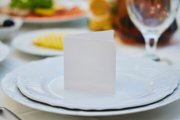 A plaque made of paper in a plate. A clear field without an inscription