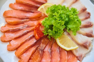 A festive dish on a plate. Several types of fish