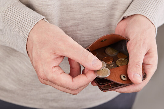 Man counting money. Leather wallet with euro money coins. Calculation of incomes and expenses. Financial literacy. Selective focus. - Powered by Adobe