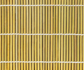 Close-up of the front surface of a bamboo mat with white threads used as a background.