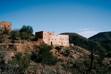 Obraz premium Traditional Berber House on a Rocky Hill in Tafraoute, Morocco – Remote Mountain Architecture
