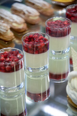 Delicious desserts displayed at a cafe during a busy afternoon