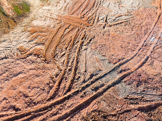 Wheel tracks on the ground on the dirt road.