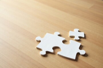 Unassembled White Jigsaw Puzzle Pieces on a Light Brown Wooden Surface Representing the Concept of Teamwork and Problem Solving