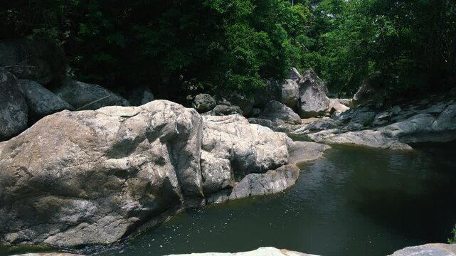 A section of a mountain river in the jungle with huge rocks