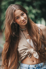 Beautiful adorable girl outdoors in the park enjoying summer day