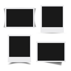 A collection of four empty photo frames, suggesting a space for images or memories.