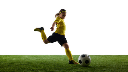 Confident girl in sports uniform controlling ball with precision, playing soccer on grassy surface...