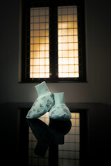 A pair of shoes for the newborn baby, near a window
