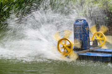 Paddle wheel aerator in the middle of a large pond