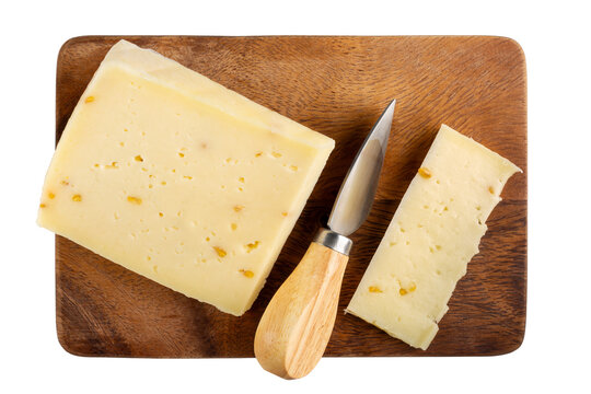 Cheese plate isolated on white background. Italian cheese caciotta with fenugreek on wooden board. Top view.