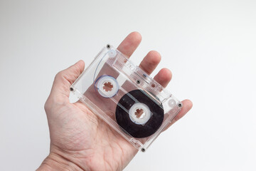 Vintage Audio Cassette Tape Held Against Clean White Background