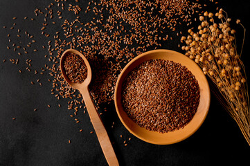 Organic cereals. Healthy eating. Flax seeds in a wooden spoon and plate