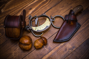 Vintage Hunting Tools and Accessories Arranged on Rustic Wooden Surface