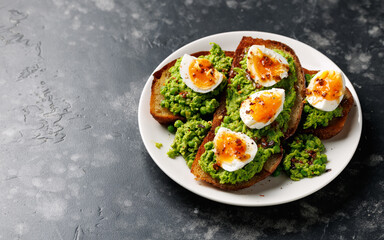 Smashed peas and egg sourdough toast with whole grain mustard sauce. Protein packed vegetarian food concept